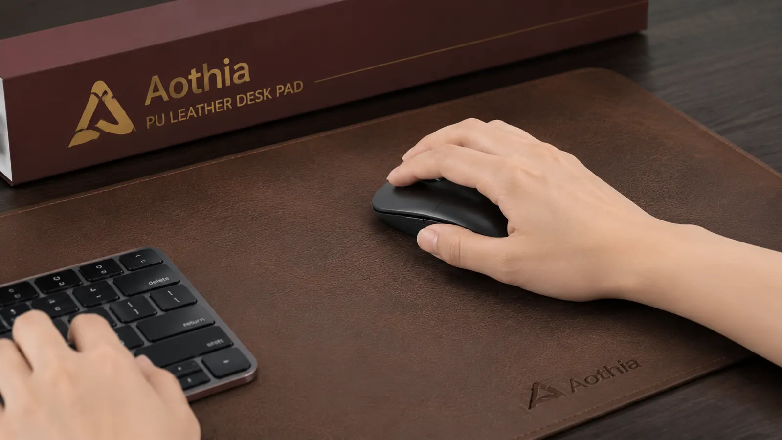 Close-up of the Aothia leather desk pad surface showing smooth PU texture with a wireless mouse gliding on it