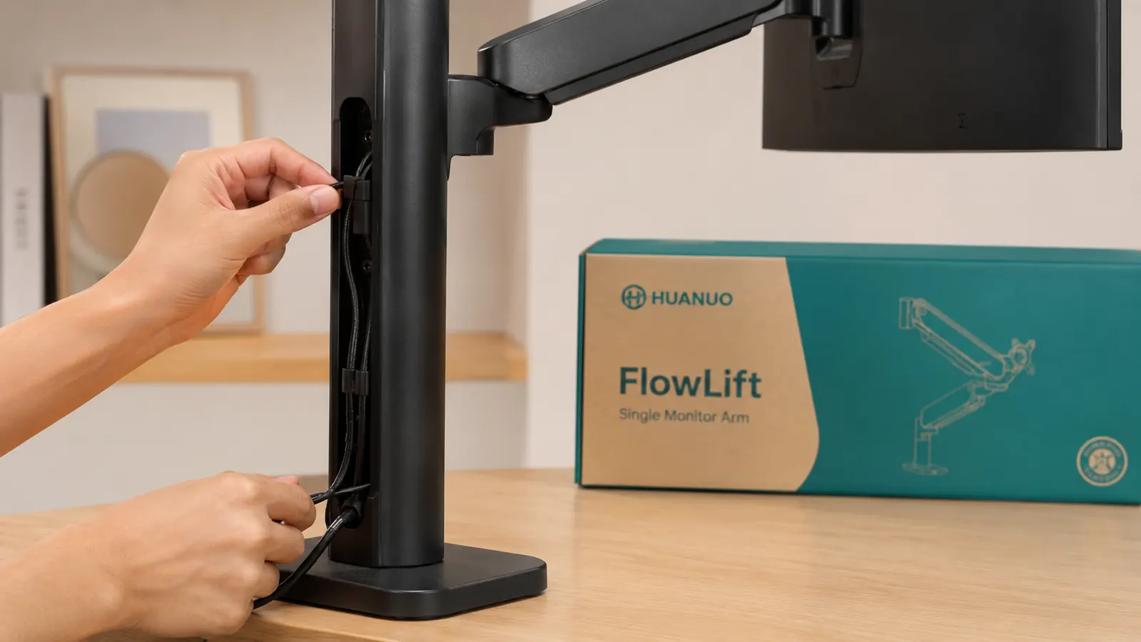 Side view of a monitor arm cable management channel with USB and display cables routed neatly along the arm